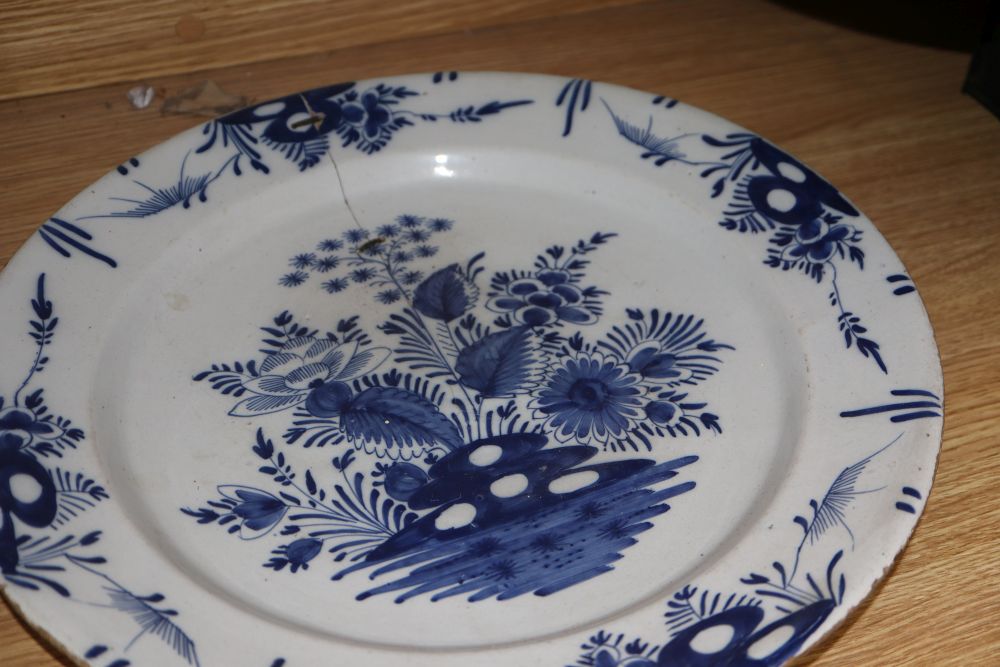 Four 18th century Delft blue and white dishes, largest 35cm (a.f.)
